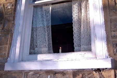 A candle in the window of the Widow's House